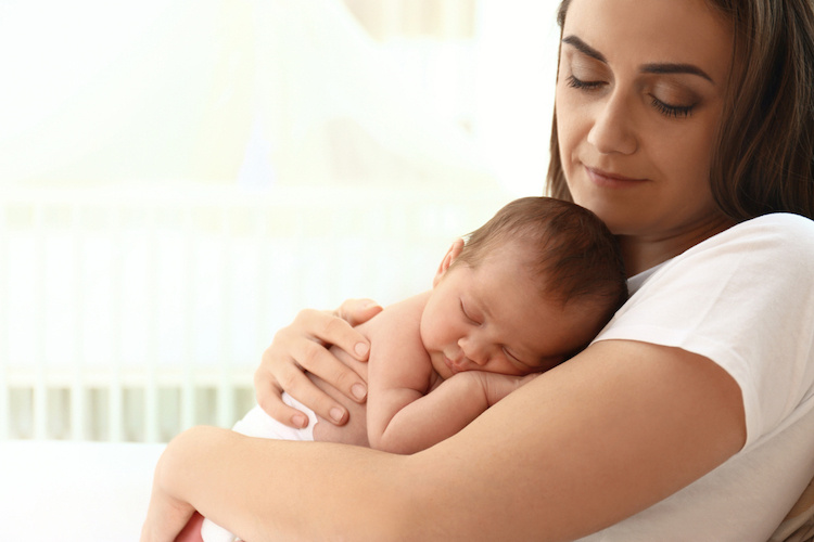 Sleeping baby in mom's arms